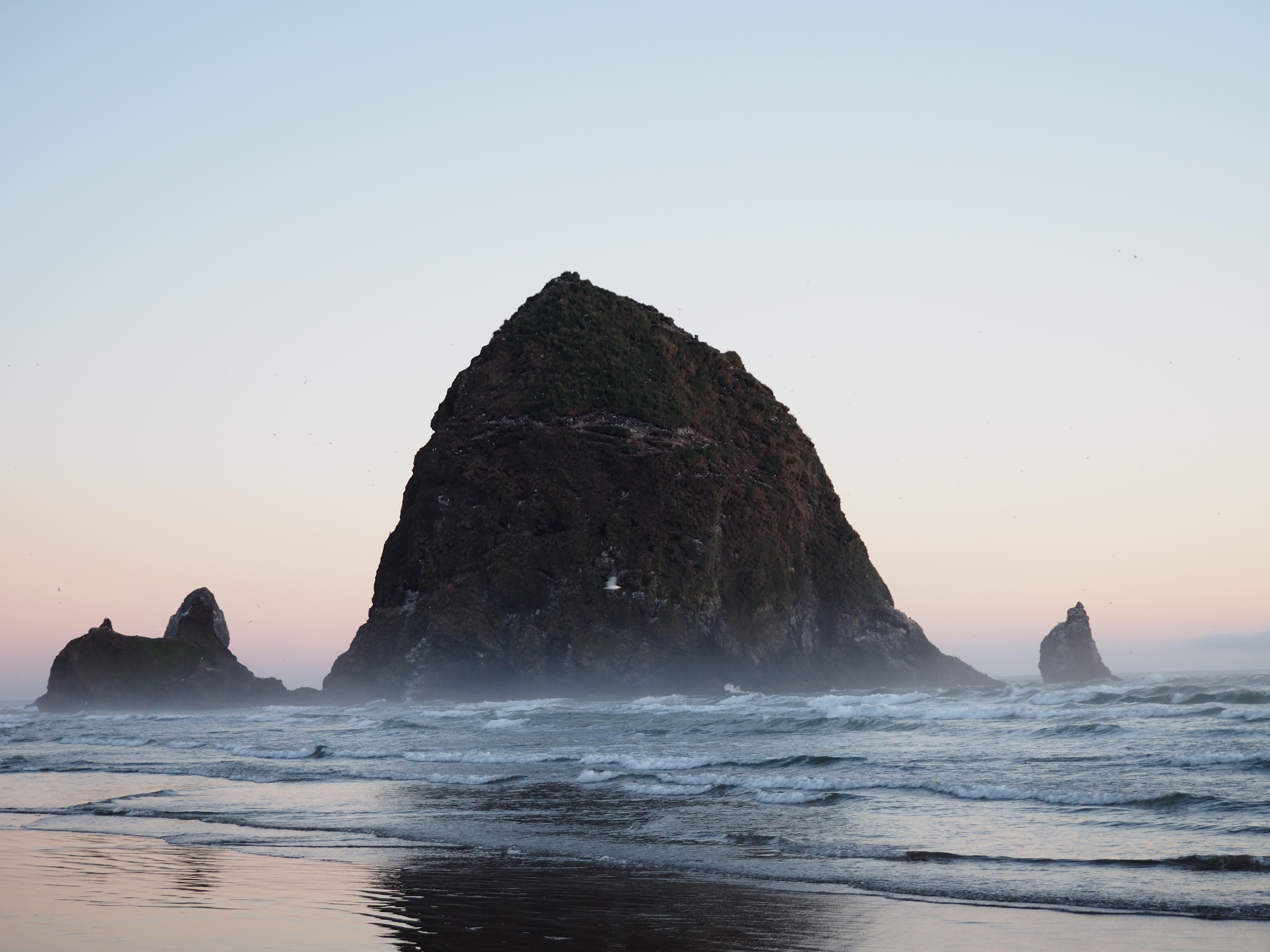 A photo of Haystack Rock located on the Oregon Coast.